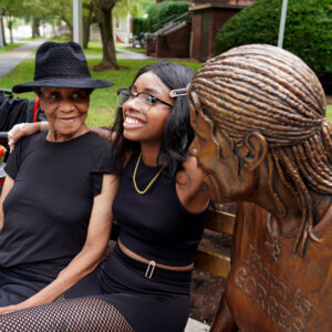 Lucy Brown with her granddaughter and statue