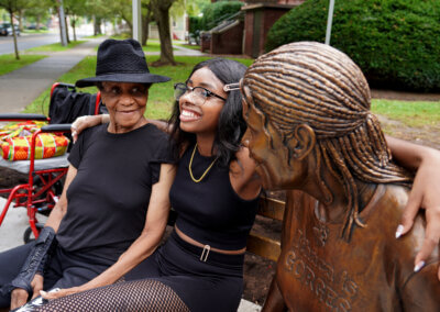 Lucy Brown with her granddaughter and statue
