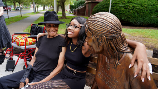 Lucy Brown with her granddaughter and statue